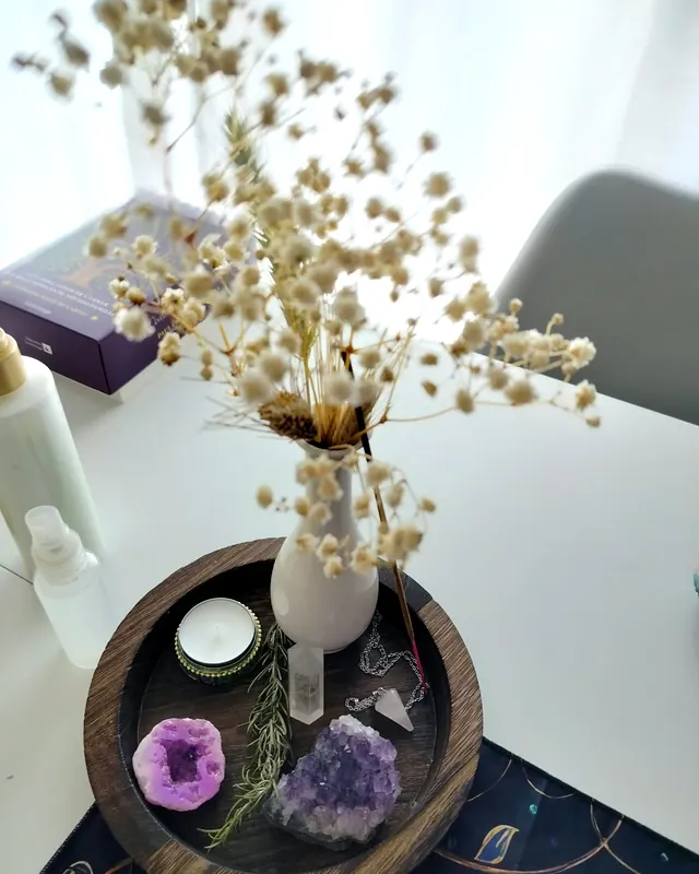 Flores secas, vela y piedras en la mesa del espacio